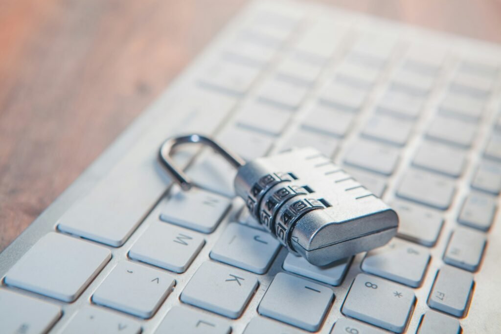 Padlock resting on a laptop keyboard, representing protection against session hijacking malware
