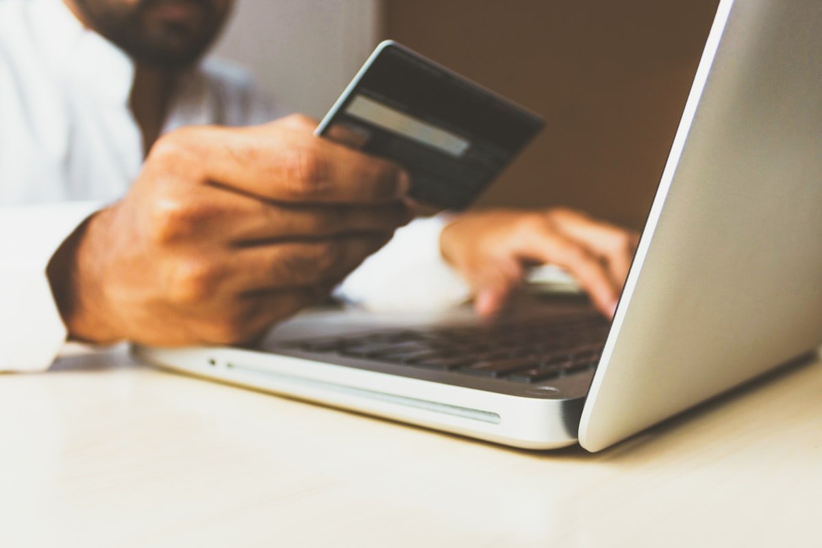 Person completing an agentic commerce online checkout with a card