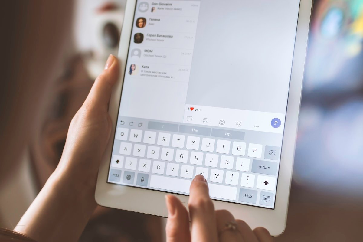 Person using a tablet chat interface, representing ChatGPT ads