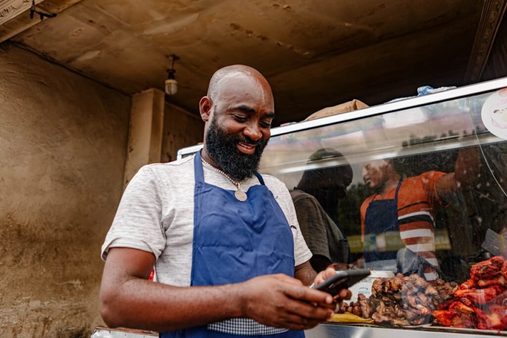 Small business owner checking his phone after AI agents are calling