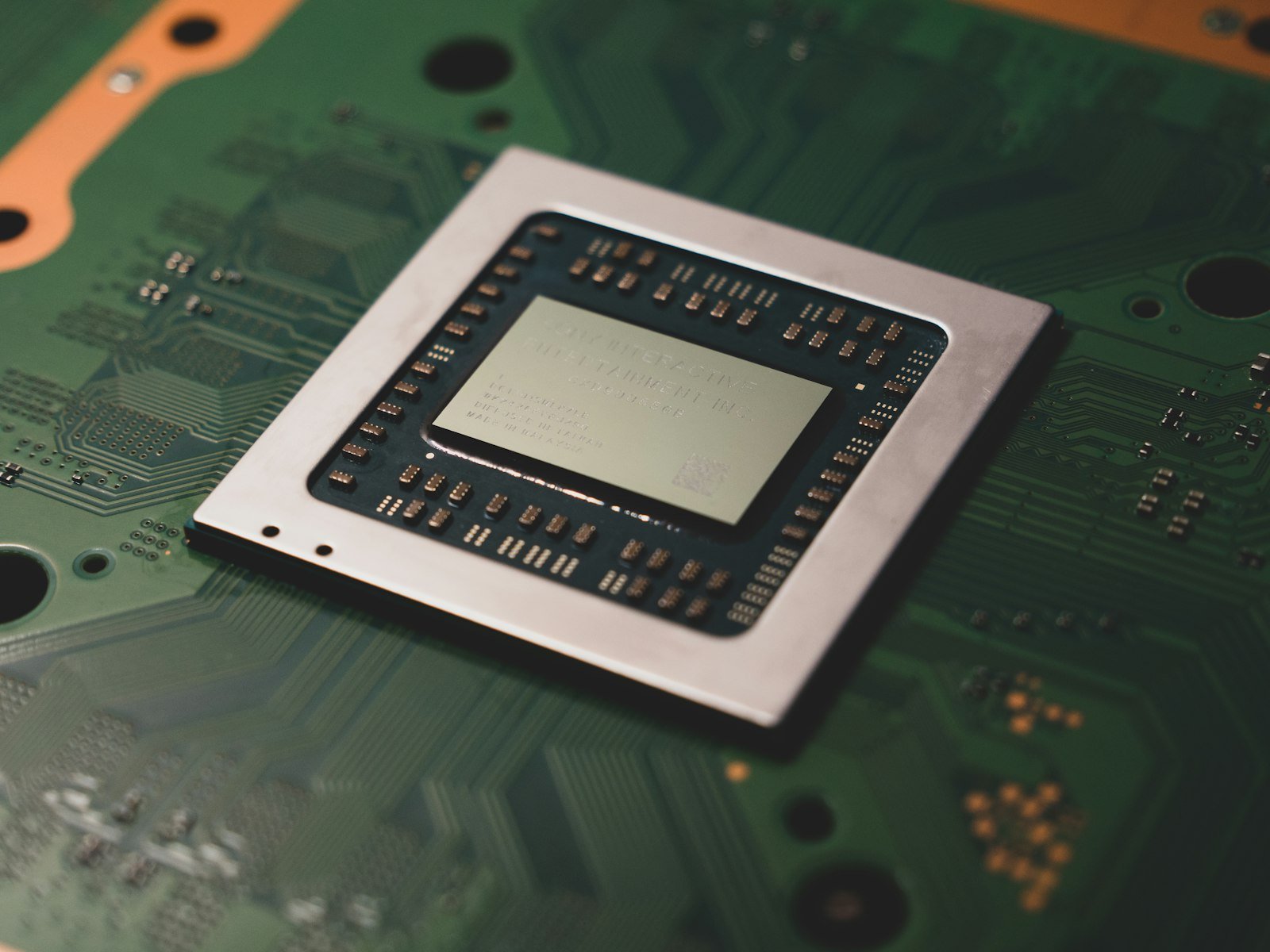Close up of a computer processor chip on a circuit board, representing AMD reaching a $1 trillion market cap