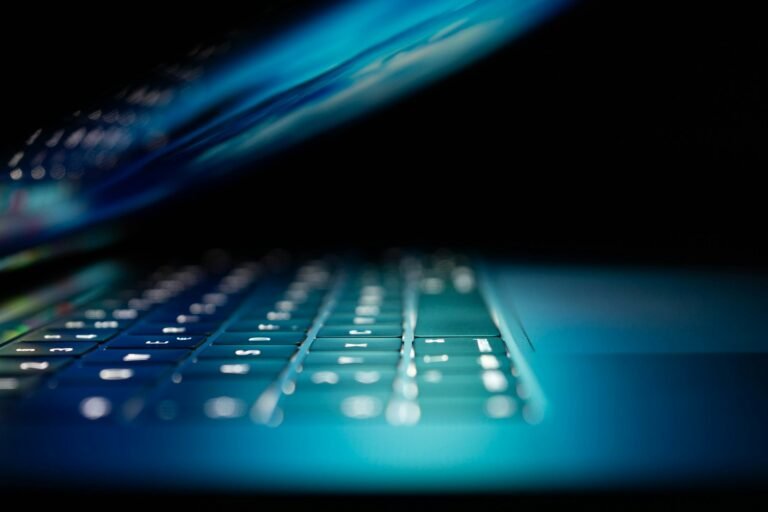 Glowing blue laptop keyboard, representing Gemini 3.8 Flash Cyber restricted security AI access