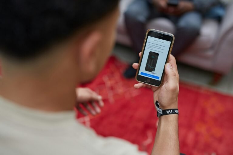 Person looking at a phone screen, representing frustrated ChatGPT subscribers during the GPT-6 Astra rollout