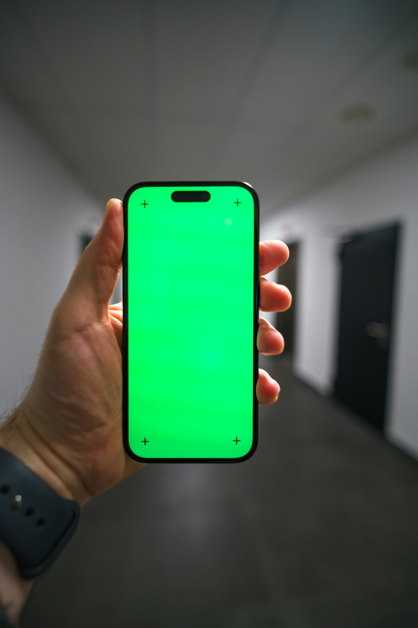 Hand holding a smartphone, representing the upcoming iPhone Fold launch